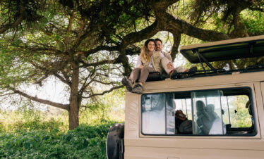 Minimum Age for Walking Safari in Tanzania Guide – tourists sitting on safari vehicle in national park