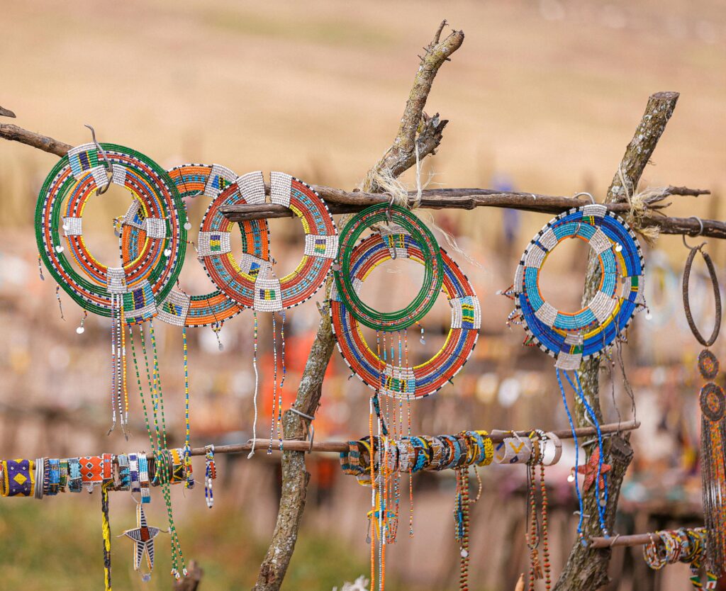 Colorful Maasai beaded jewelry displayed at a handicraft market in Tanzania, showing how safari tourism supports local communities in Tanzania through cultural craftsmanship and income generation.
