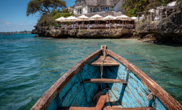Boat approaching The Rock Restaurant at high tide in Zanzibar