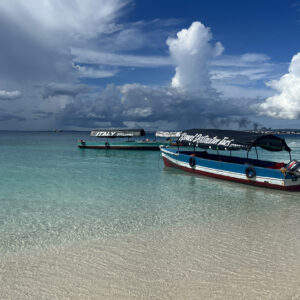 Boat approaching a sandbank in Zanzibar during late afternoon