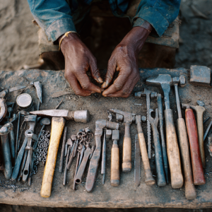 Datoga craft hands working with metal tools near Lake Eyasi