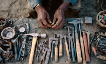 Datoga craft hands working with metal tools near Lake Eyasi