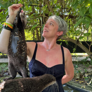 Guests interacting with otters under staff supervision at Cheetah’s Rock in Zanzibar