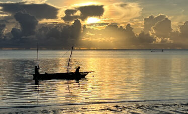 Traditional Fishing Boat at sunrise off the coast of Zanzibar at Jambiani