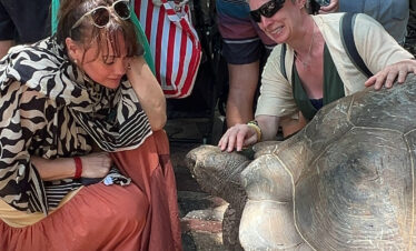 Giant Aldabra tortoise and tourists at Prison Island