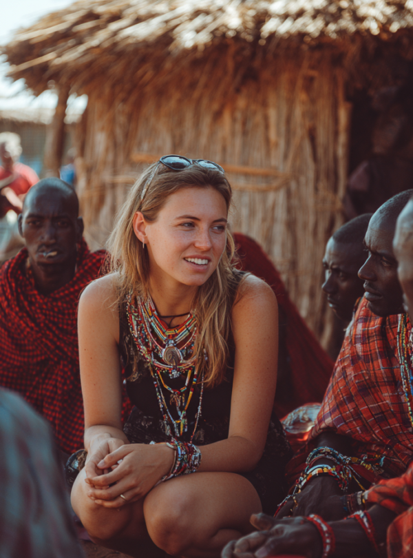 Guests talking with Maasai community members during a village visit