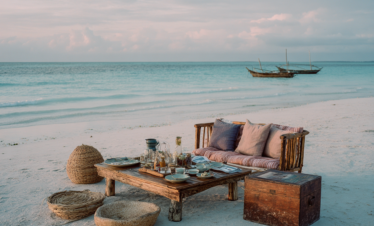 Private beach picnic setup on a secluded Zanzibar beach in the evening