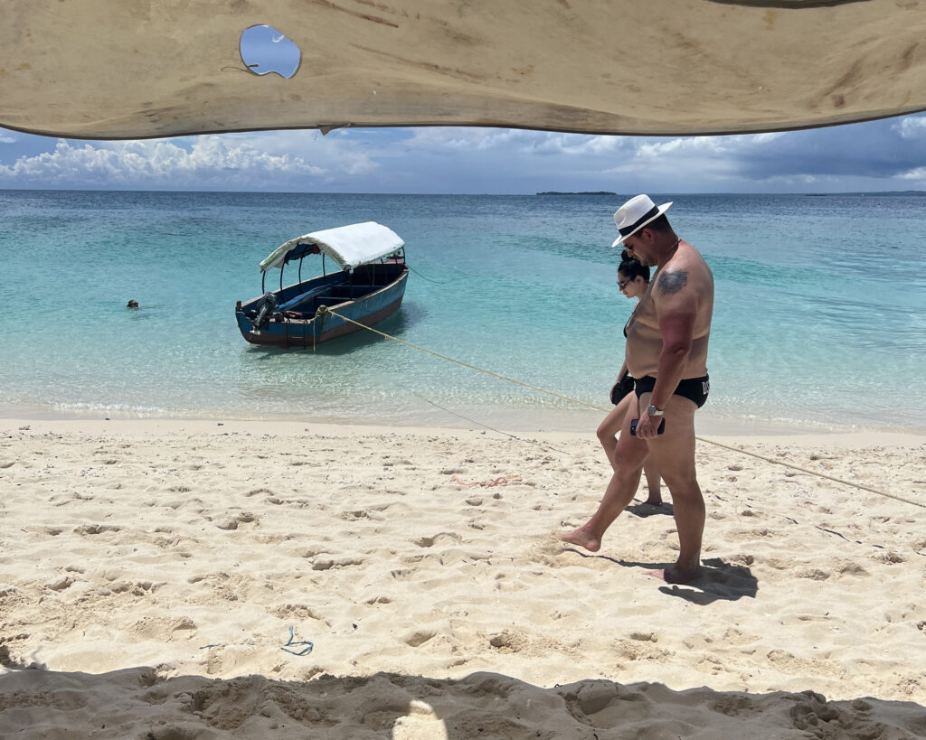 Couple walking quietly on a sandbank in Zanzibar