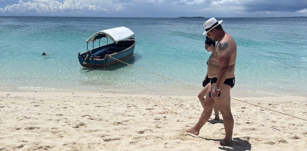 Couple walking quietly on a sandbank in Zanzibar