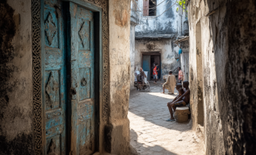 Narrow Stone Town alley with carved wooden doors in Zanzibar