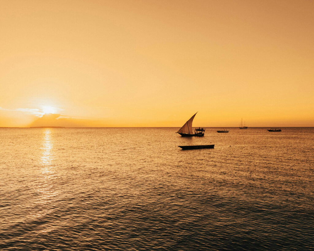 Traditional Dhow sailing boat at sunset in Zanzibar