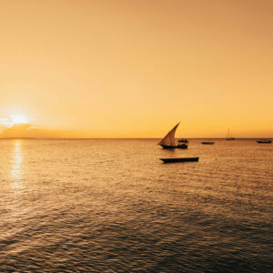 Traditional Dhow sailing boat at sunset in Zanzibar