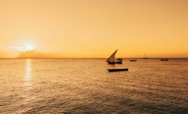 Traditional Dhow sailing boat at sunset in Zanzibar