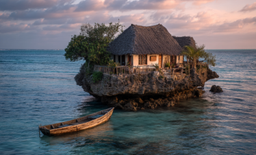 The Rock Restaurant surrounded by ocean at sunset in Zanzibar