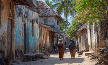 Village pathway with residents going about daily life in Zanzibar