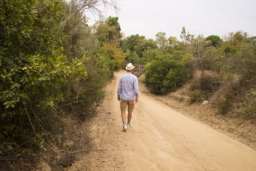 Man walking in Tanzania wilderness during Best Tanzania walking safari experience with professional guide