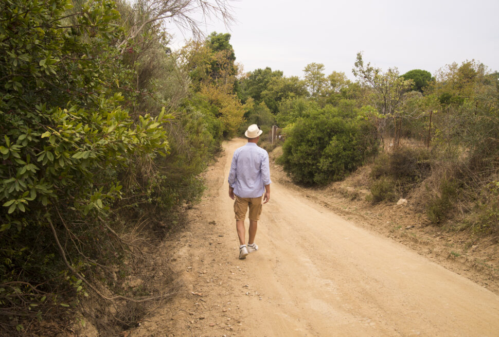 Man walking in Tanzania wilderness during Best Tanzania walking safari experience with professional guide