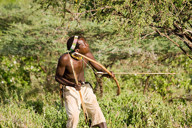 Hadzabe hunter demonstrating ancient traditions during Hadzabe Tribe Tour in Tanzania