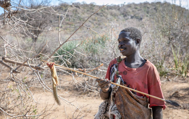 Hadzabe man demonstrating hunting skills during Bush Walk on a Hadzabe Tribe Tour in Tanzania