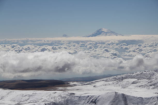 Aerial view of Mount Kilimanjaro above the clouds in Tanzania, Africa’s highest peak and a popular destination for Kilimanjaro adventure tours