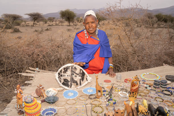 Maasai woman selling handmade bead jewelry and souvenirs during Maasai Village Tours in Tanzania