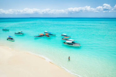 Nungwi Beach aerial view of white sand and turquoise water with boats Zanzibar