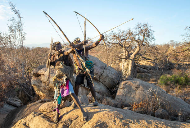 Hadzabe men with bow and arrows at Lake Eyasi Tanzania showcasing traditional tribal life for Understanding Cultural Tourism in Tanzania