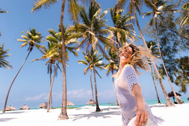 Solo female traveler enjoying a sunny day at a Zanzibar beach, Tanzania, during a solo travel adventure