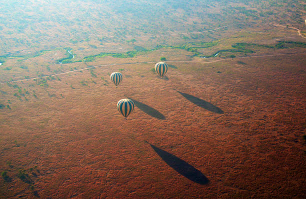 Hot air balloons over Serengeti National Park at sunrise, perfect for couples on a Romantic Safari Adventure in Tanzania