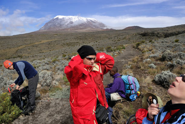 How Difficult Is It to Climb Mount Kilimanjaro? Climbers resting during ascent in Kilimanjaro, Tanzania