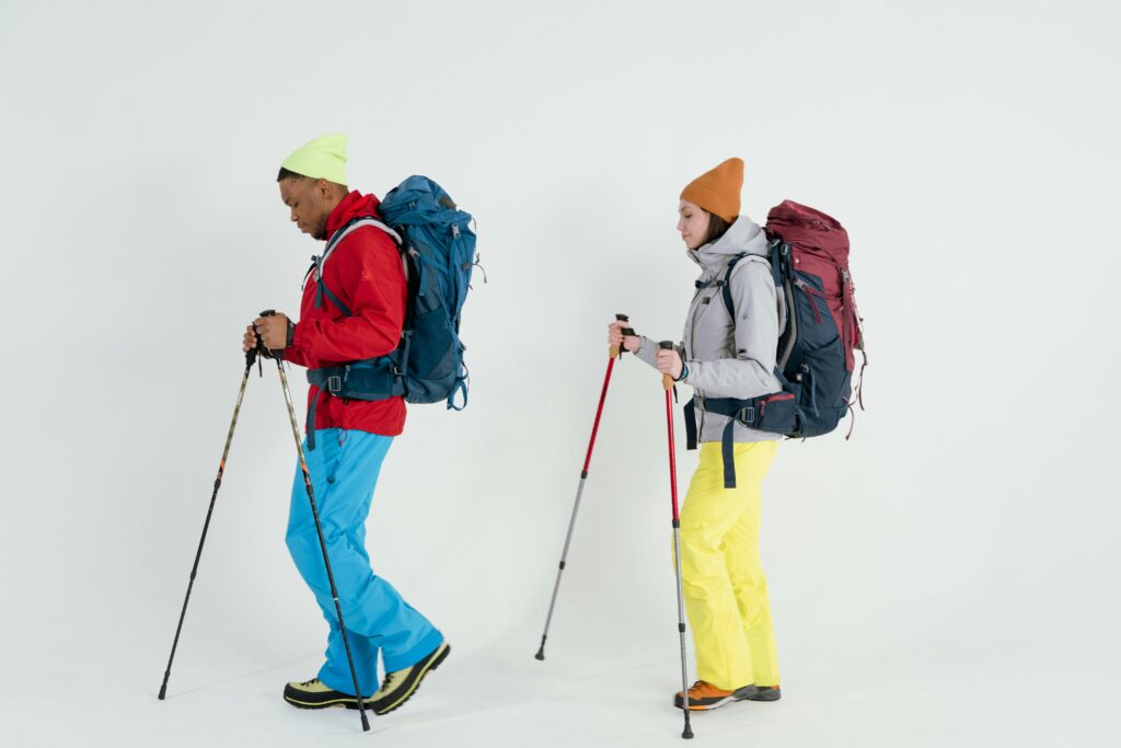 Two trekkers carrying backpacks and duffel bags during a Mount Kilimanjaro trek, demonstrating essential gear from a Mount Kilimanjaro Packing List