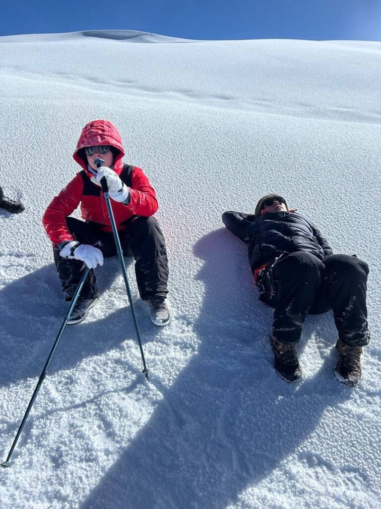 Climbers trekking at night on Mount Kilimanjaro, moving slowly in cold, dark conditions during summit push.