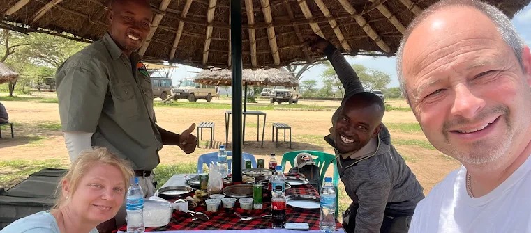 Private vs Group Safari in Tanzania couple enjoying romantic private safari lunch experience with JoyTrekking Tours & Safaris