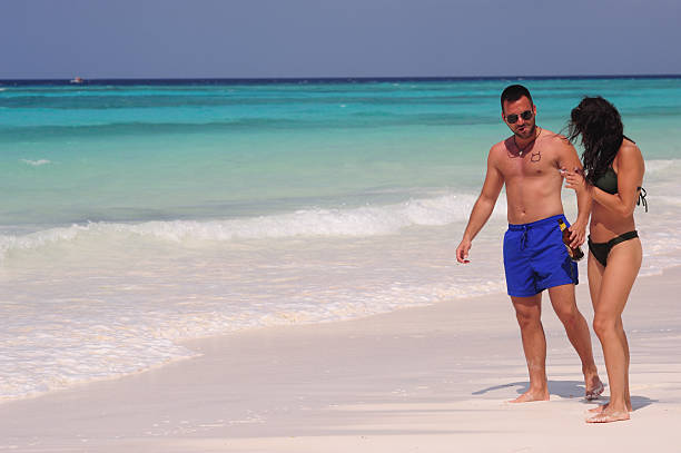 Young couple enjoying Zanzibar beach at one of the best honeymoon destinations in Tanzania