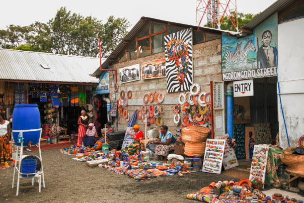 African women selling handmade handicrafts with Tanzanian cultural themes at Maasai Market in Arusha, featured in Arusha City Travel Guide 2026