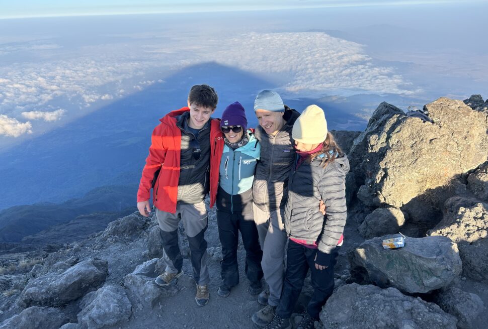 “Four international climbers trekking Mount Kilimanjaro routes in Tanzania during summit expedition”