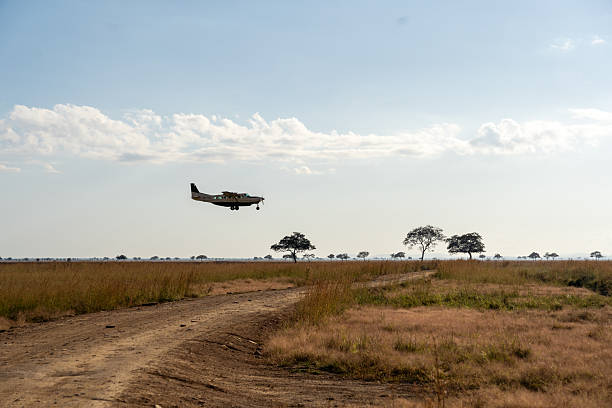 Fly-In Safari Tour experience in Tanzania. Aircraft flying above Serengeti plains during a Tanzania