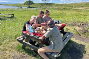 Tanzania safari seasons peaceful picnic experience near hippo pool where visitors stop for lunch during game drive
