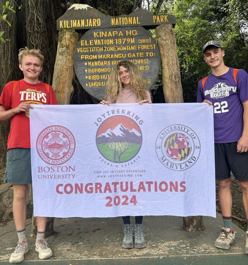 Tanzania Safari Booking Guide featuring international travelers at Kilimanjaro National Park HQ with JoyTrekking Tours & Safaris in Tanzania