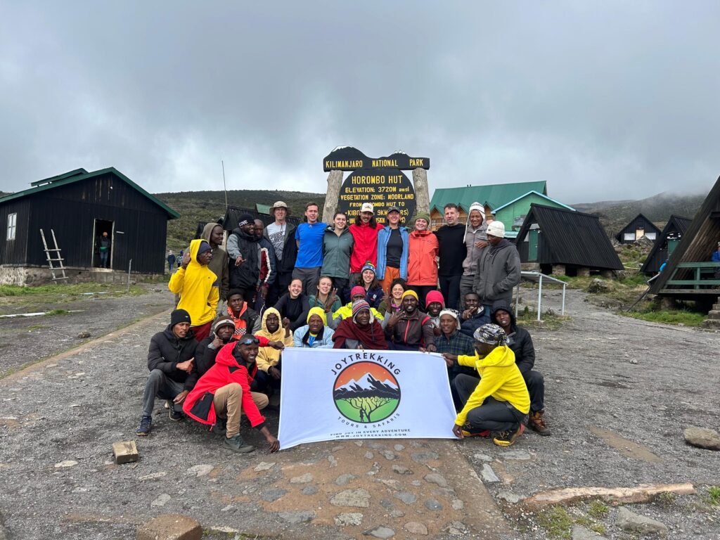Guests with JoyTrekking Tours & Safaris porters during a Kilimanjaro trekking adventure at Horombo Hut