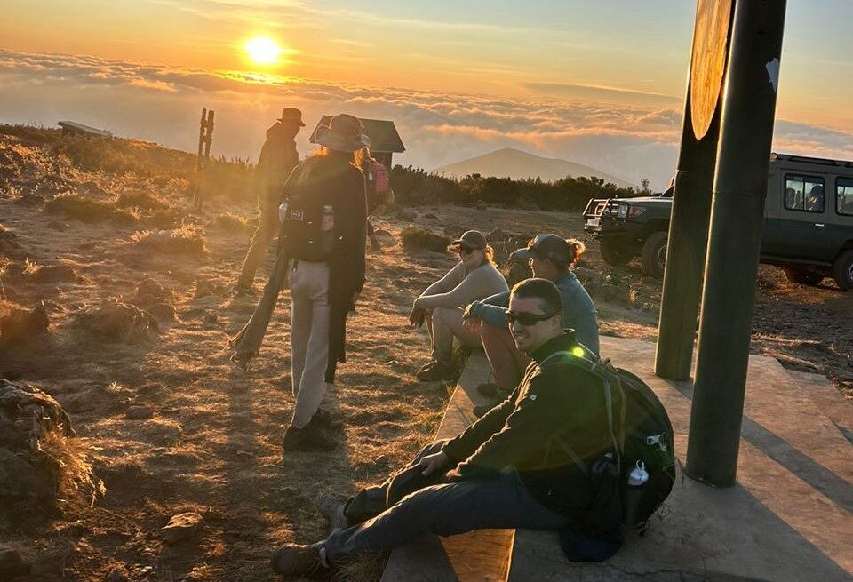Cost of Climbing Mount Kilimanjaro – climbers at a mountain camp enjoying sunrise views during a Kilimanjaro trekking expedition in Tanzania