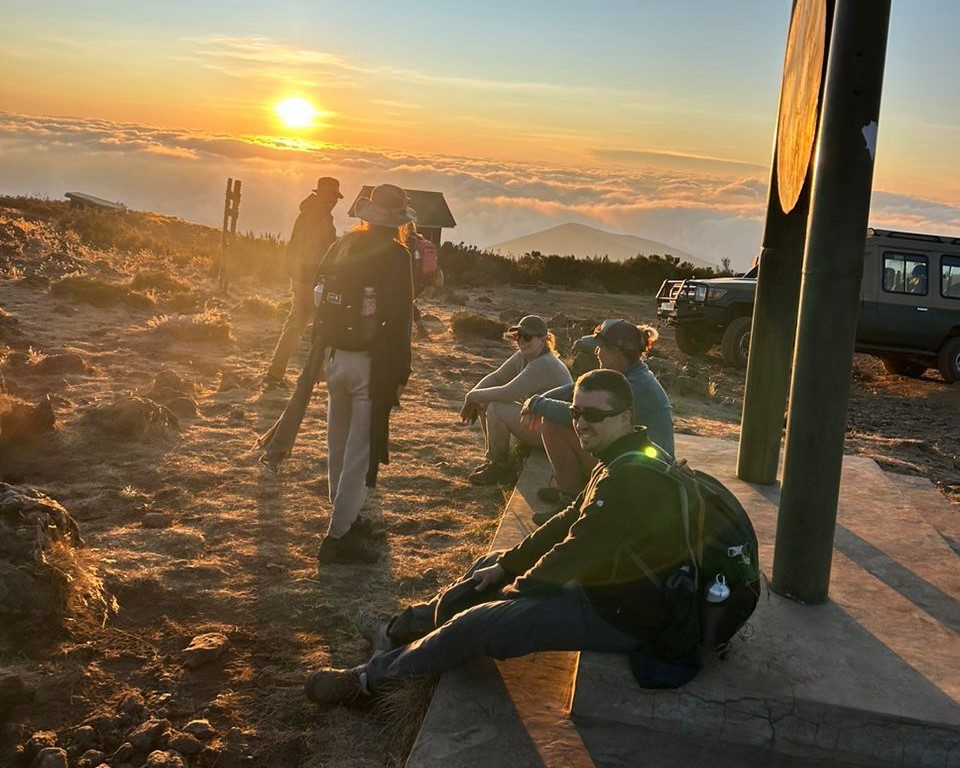Cost of Climbing Mount Kilimanjaro – climbers at a mountain camp enjoying sunrise views during a Kilimanjaro trekking expedition in Tanzania