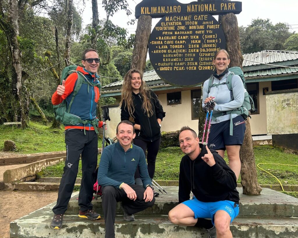 Best Tanzania travel experts Machame Gate Kilimanjaro climbers group photo at starting point of Machame Route Mount Kilimanjaro trek