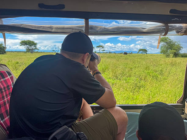 Wildlife photographers on a Tanzania safari using a photography-friendly safari vehicle during a mid-range safari experience
