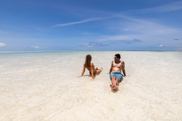 Zanzibar Honeymoon Cost experience with a happy couple relaxing together in the warm Indian Ocean waters in Zanzibar.