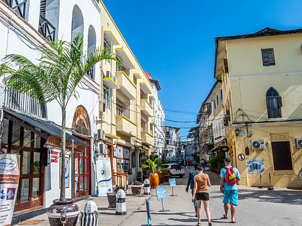 Travelers walking through the historic streets of Stone Town, Zanzibar, during a guided city tour on a 5 day Zanzibar trip.