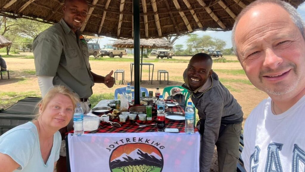 Safari guests enjoying a picnic lunch with their guide inside Tarangire National Park