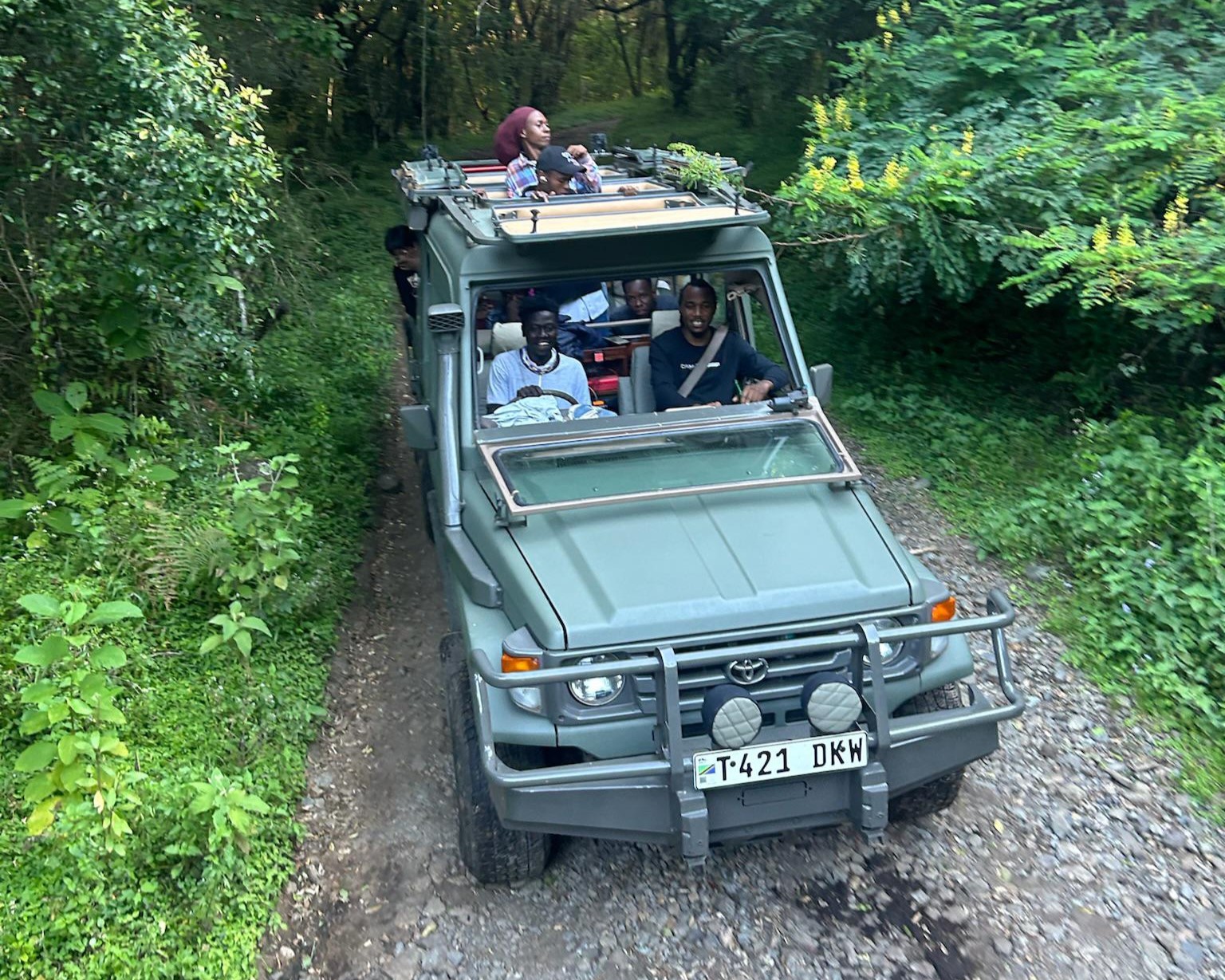 Best pre-climb activities in Arusha featuring guests enjoying a game drive before climbing Mount Kilimanjaro