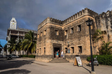 Tourists exploring the Old Fort on a Stone Town tour in Zanzibar before comparing Stone Town tour costs and guided experiences
