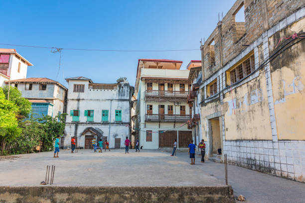 Children playing on the historic streets of Stone Town Zanzibar during a Stone Town Walking Tour showcasing authentic local life and culture